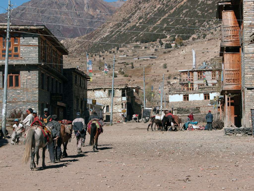 Annapurna 13 01 Manang Manang (3540m) is the main village of the upper valley and could easily be a town in a spaghetti western. These horses are being led up the wide dusty streets in very windy conditions, Clint ... where are you?